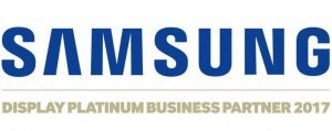 The image shows the Samsung logo in blue above gold text stating Display Platinum Business Partner 2017, displayed on a white background. This sign highlights Logando’s recognition as a top-tier Samsung business partner.