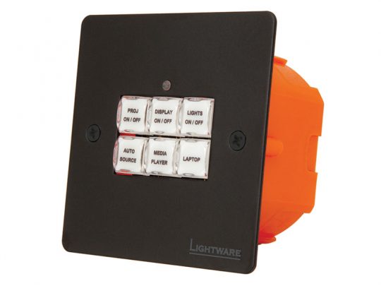 Lightware wall-mounted AV control panel in black with six labeled white buttons for projector, display, lights, auto source, media player, and laptop functions. Brand logo is shown on the lower right corner.
