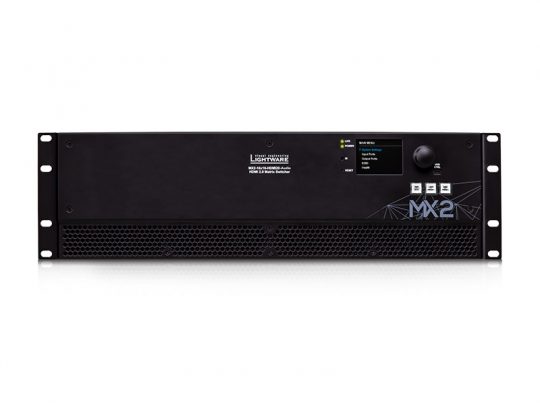 Front view of the Lightware MX2-16x16 HDMI matrix switcher, showing its black rectangular rack-mountable design with a digital display, navigation control buttons, and ventilation grill for cooling. Ideal for professional AV signal management.