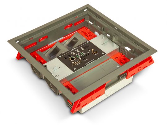 Open floor box with gray and red frame, displaying multiple network ports, audio jacks, and control switches on a black central panel; product shown at an angle on a white background.
