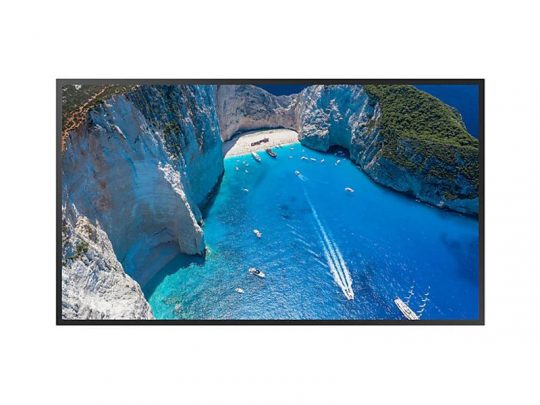 Samsung 4K Ultra HD Smart TV displaying an aerial image of a vibrant blue bay encircled by towering white cliffs, boats floating on the water, and a small sandy beach nestled between the cliffs; perfect for immersive home entertainment.