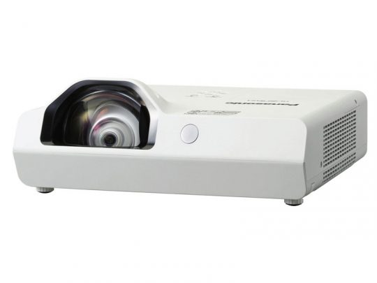 White Panasonic short-throw projector with a large front lens, side ventilation grilles, and top control buttons, displayed on a white surface.