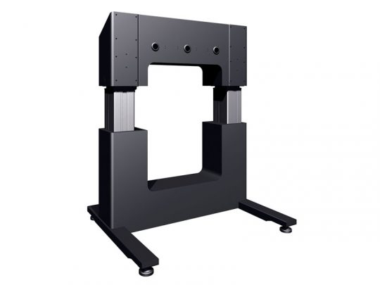 Black industrial U-shaped frame with two vertical columns and a horizontal top bar, standing on a sturdy base with four feet; likely used as material testing equipment or a universal testing machine.
