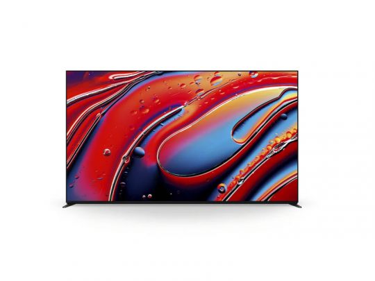 Samsung flat-screen television displaying a vibrant abstract image with swirling red, blue, and orange colors and bubble-like shapes, set against a plain white background.