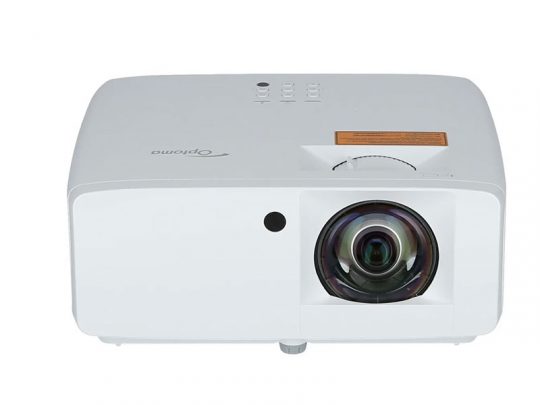 White Optoma projector with a large front-facing lens on the right, top control buttons, and a small sensor or indicator light on the front left side; ideal for home theater or office presentations.