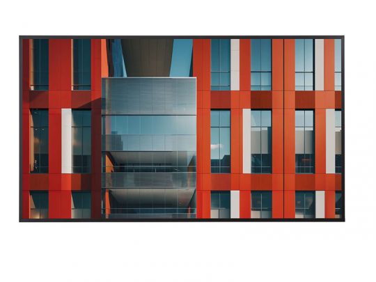 Modern commercial building facade with striking vertical panels in red, white, and dark grey, accented by large reflective glass windows and sharp geometric architectural details.