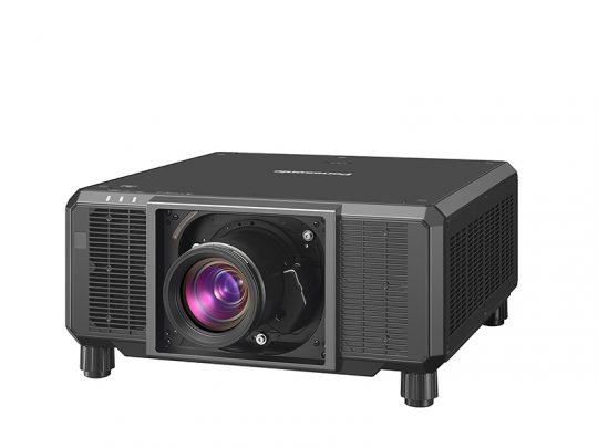 Black Panasonic projector with a large front-facing lens, four short legs, and side ventilation grills, designed for high-quality image projection.